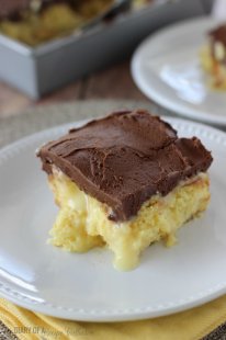 Boston Cream Pie Poke Cake - Major crowd-pleasing cake filled with vanilla pudding and sweetened condensed milk and topped with a homemade chocolate frosting!!